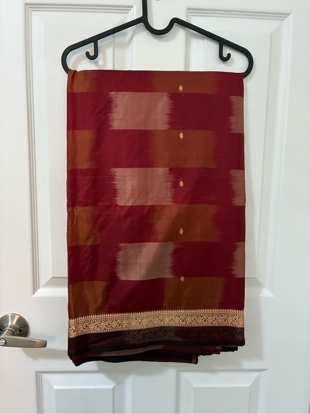 Red saree with gold accents